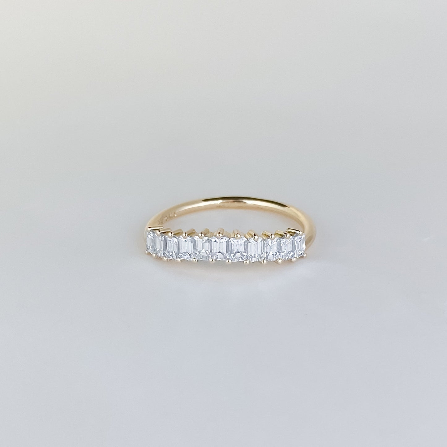 0.68 TCW Emerald Shaped Curved Moissanite Wedding Band