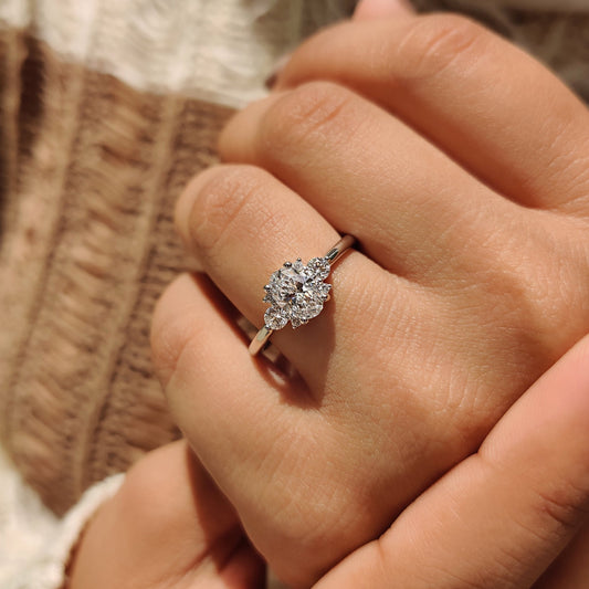 Oval Diamond Ring With Round Cut Side Stone