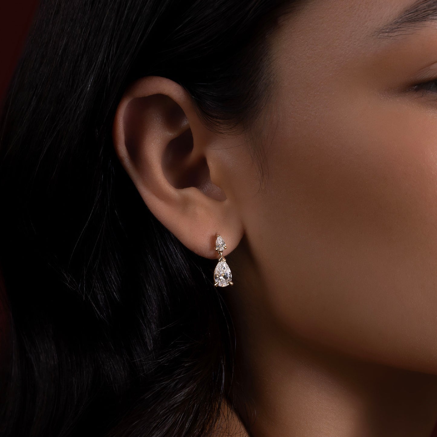 1.2 TCW Pear Cut Moissanite Dangles Earrings in Gold